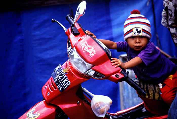 boy on motorbike-AsiaPhotoStock